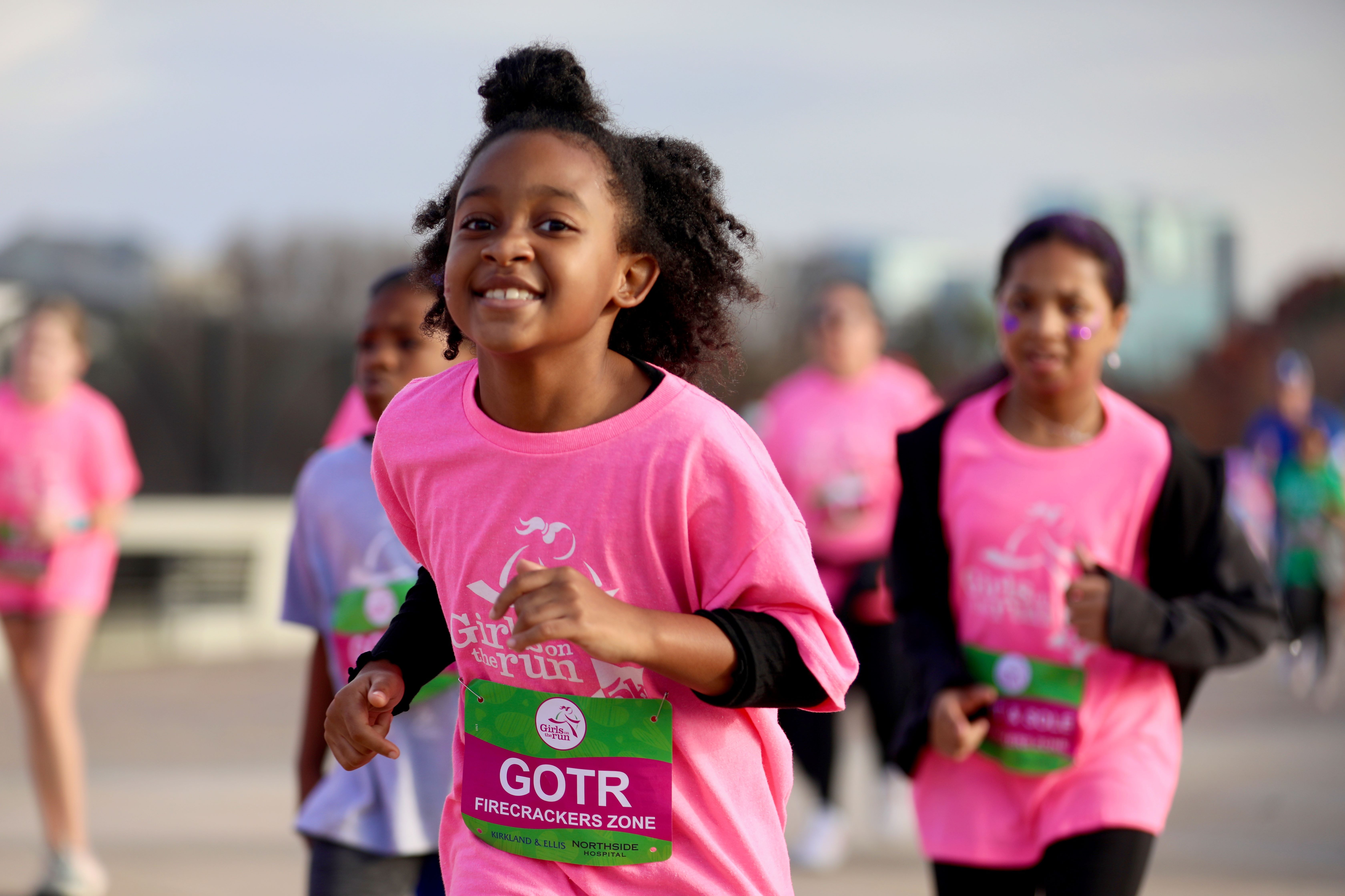 A Girls on the Run participant smiling as she participates in the 5K.